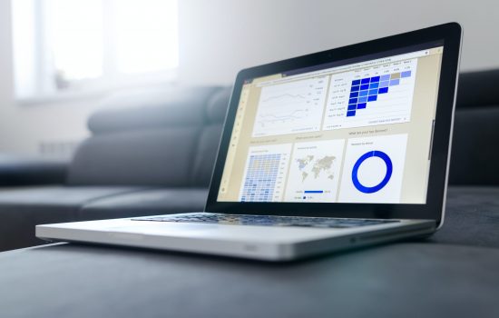 Laptop showing a custom coded dashboard containing data.